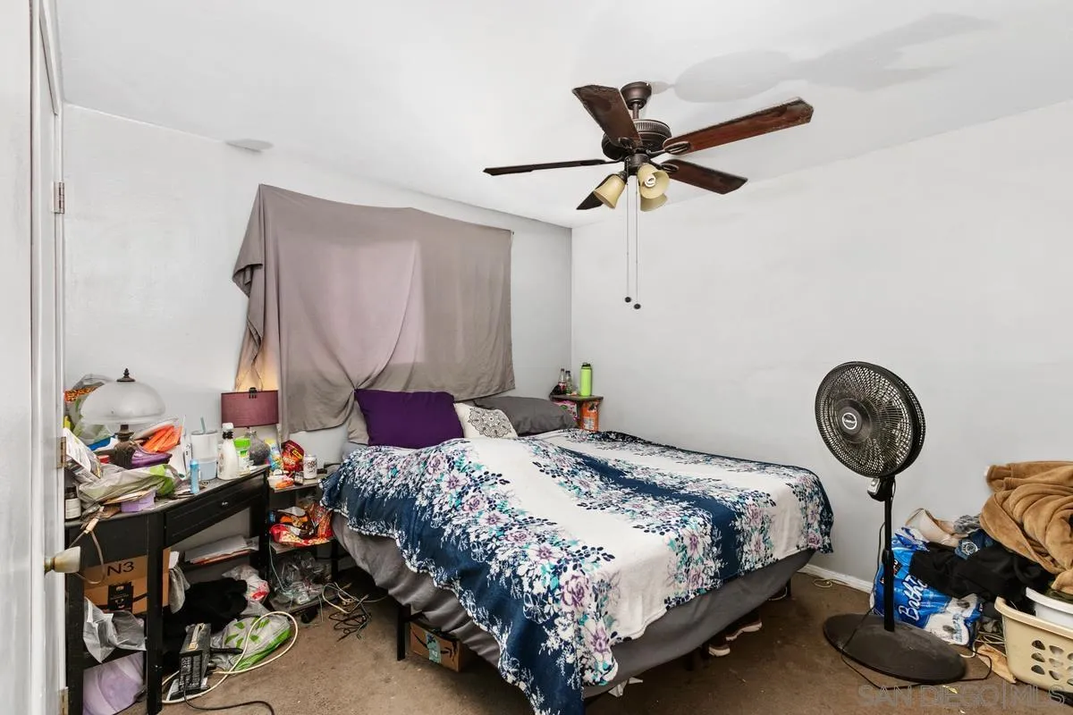 9136 Northcote Road Santee, CA 92071 - Photo 6 of 10 a bedroom with a bed and a chandelier