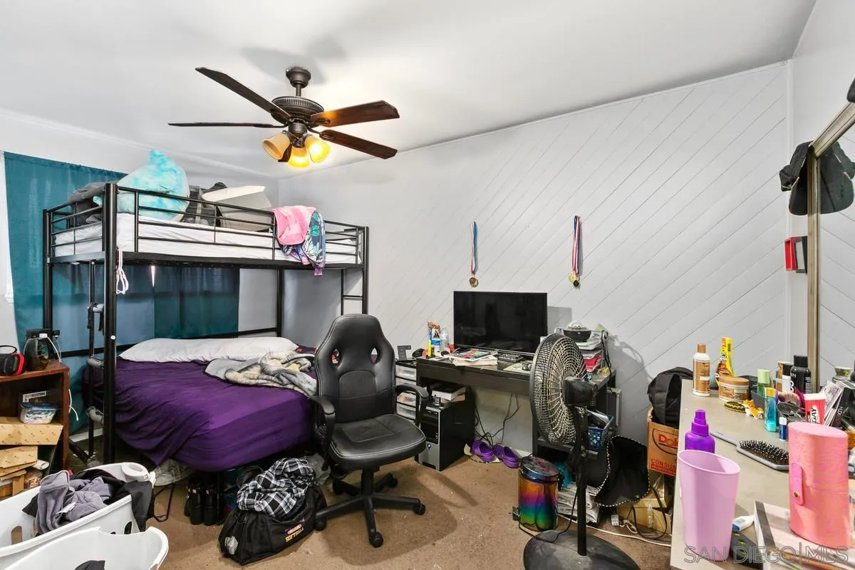 9136 Northcote Road Santee, CA 92071 - Photo 7 of 10 a bed room with a bed a flat screen tv and a window