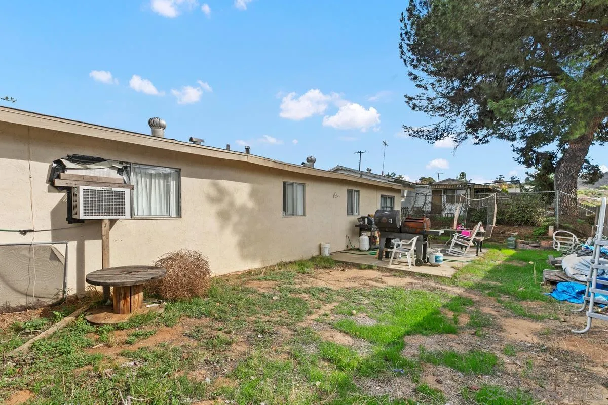 9136 Northcote Road Santee, CA 92071 - Photo 10 of 10 a view of a backyard with table and chairs a barbeque and wooden fence