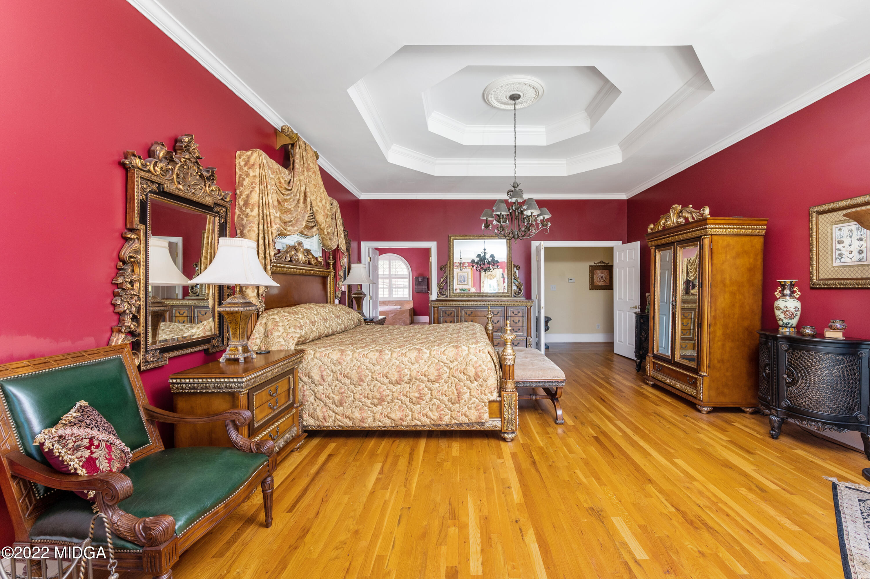 176 Tumbling Shoals Drive Gray, GA 31032 - Photo 14 of 51 a spacious bedroom with a bed and a chandelier