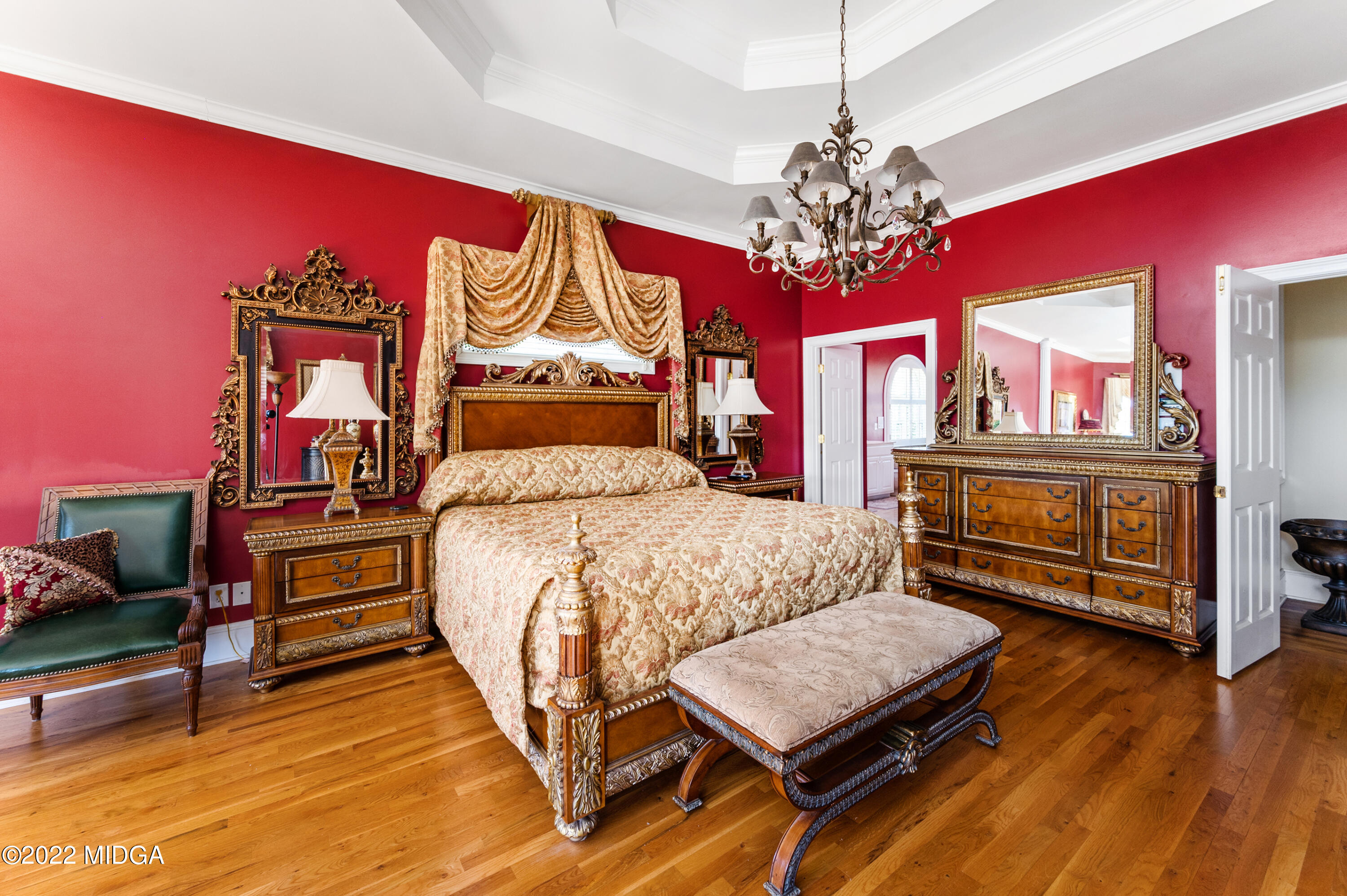 176 Tumbling Shoals Drive Gray, GA 31032 - Photo 15 of 51 a bedroom with a bed dresser and a chandelier