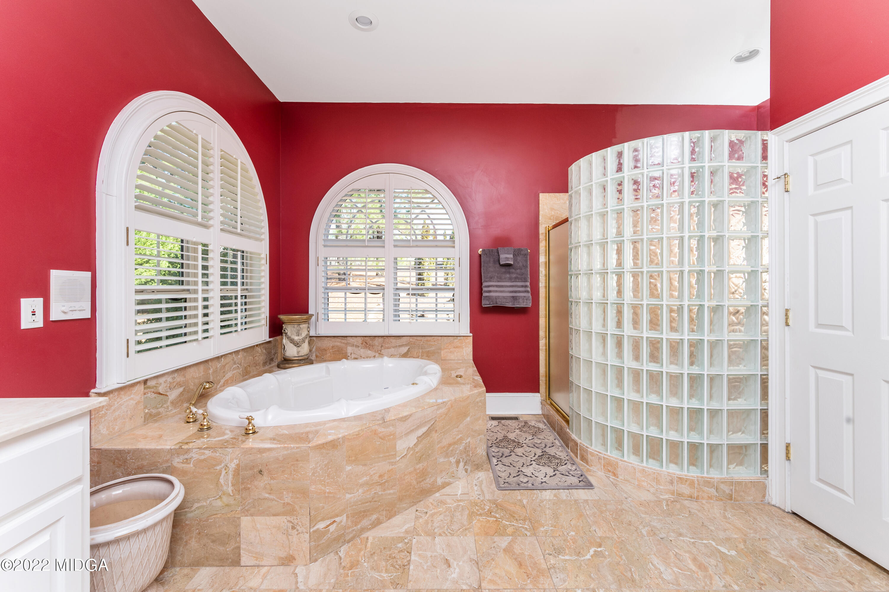 176 Tumbling Shoals Drive Gray, GA 31032 - Photo 17 of 51 a spacious bathroom with a granite countertop bathtub and window