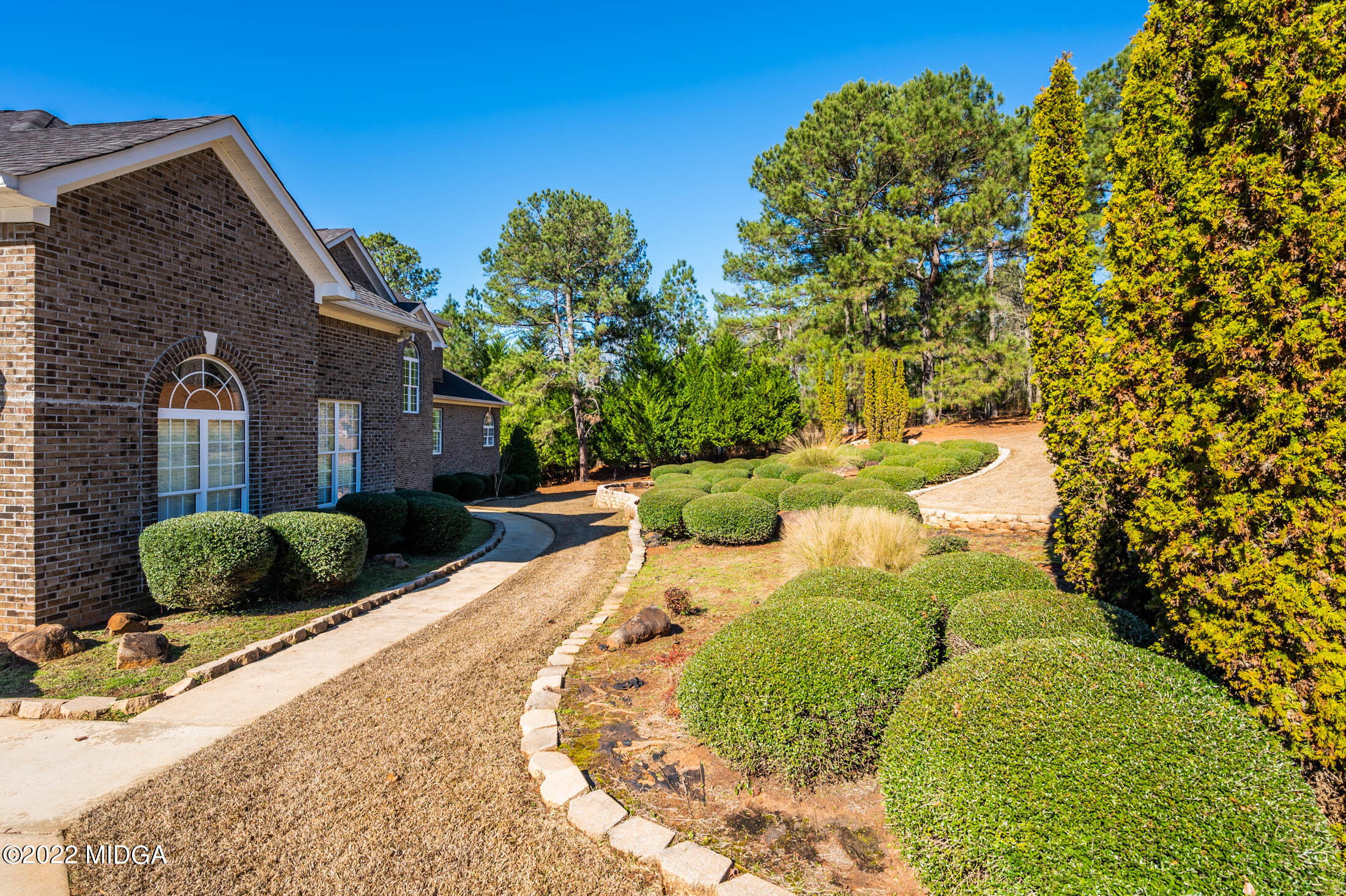 176 Tumbling Shoals Drive Gray, GA 31032 - Photo 2 of 51 a view of a backyard with plants and a tree