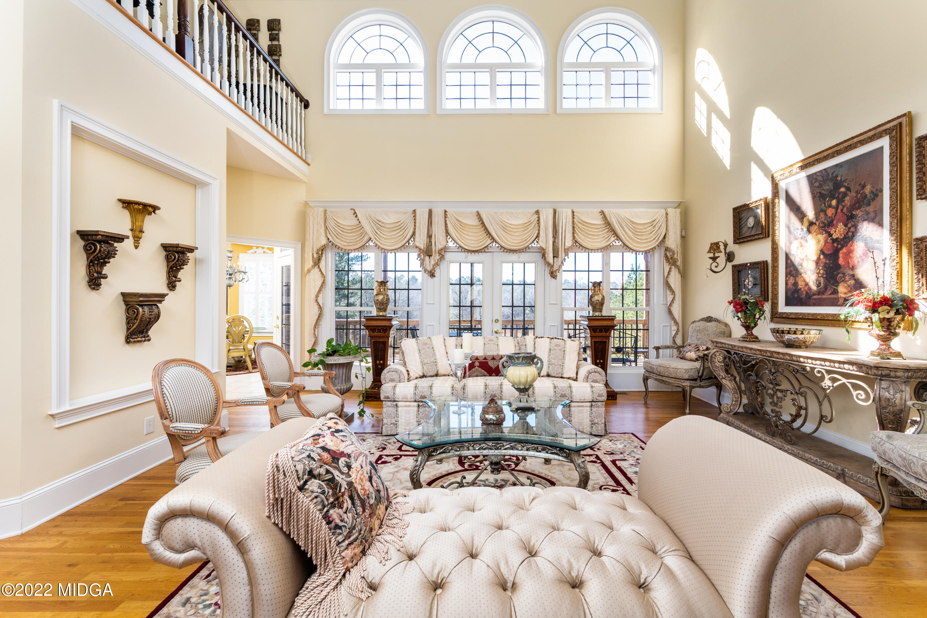 176 Tumbling Shoals Drive Gray, GA 31032 - Photo 22 of 51 a living room with furniture fireplace and a large window