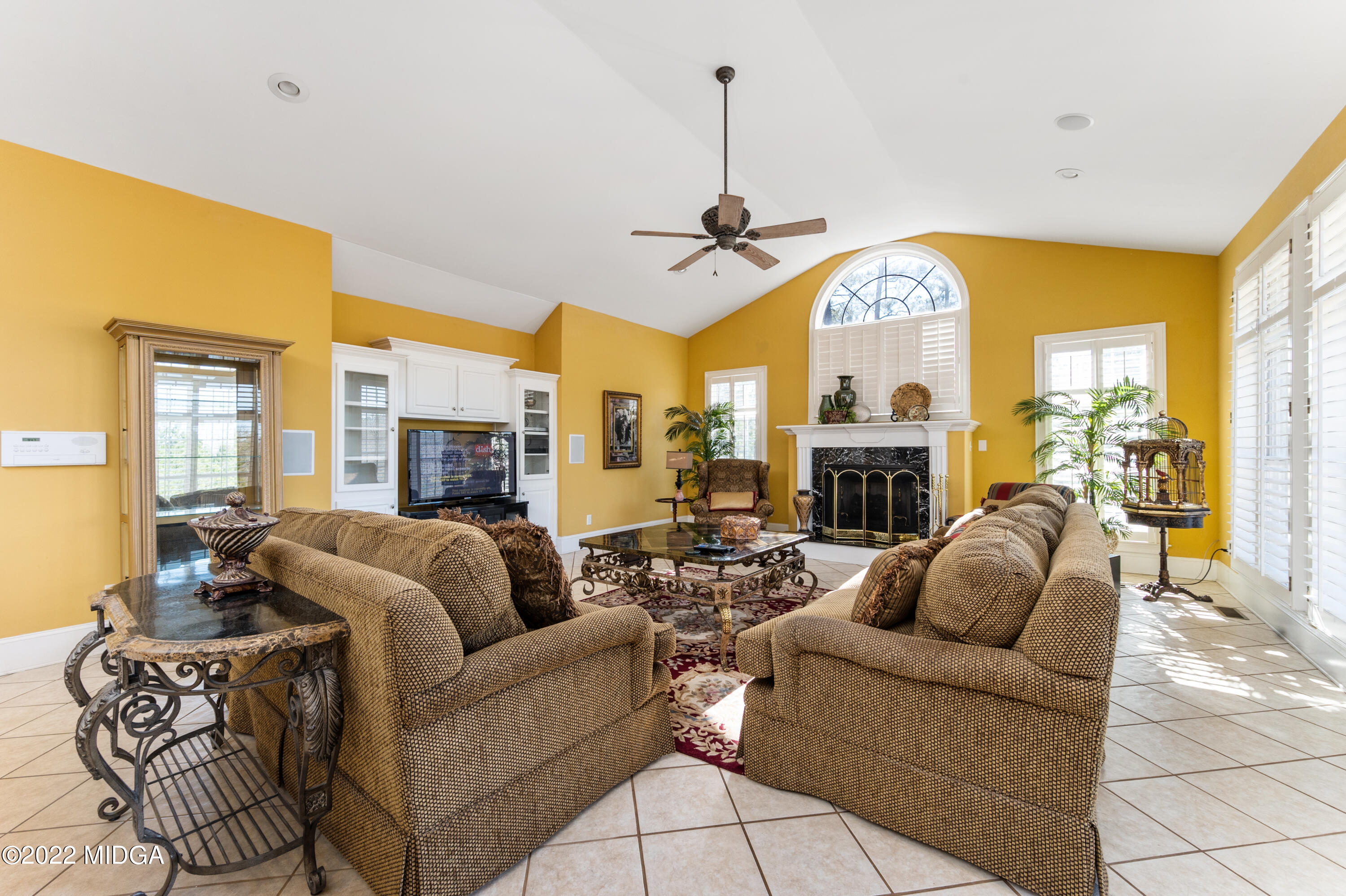 176 Tumbling Shoals Drive Gray, GA 31032 - Photo 25 of 51 a living room with furniture a fireplace and a large window