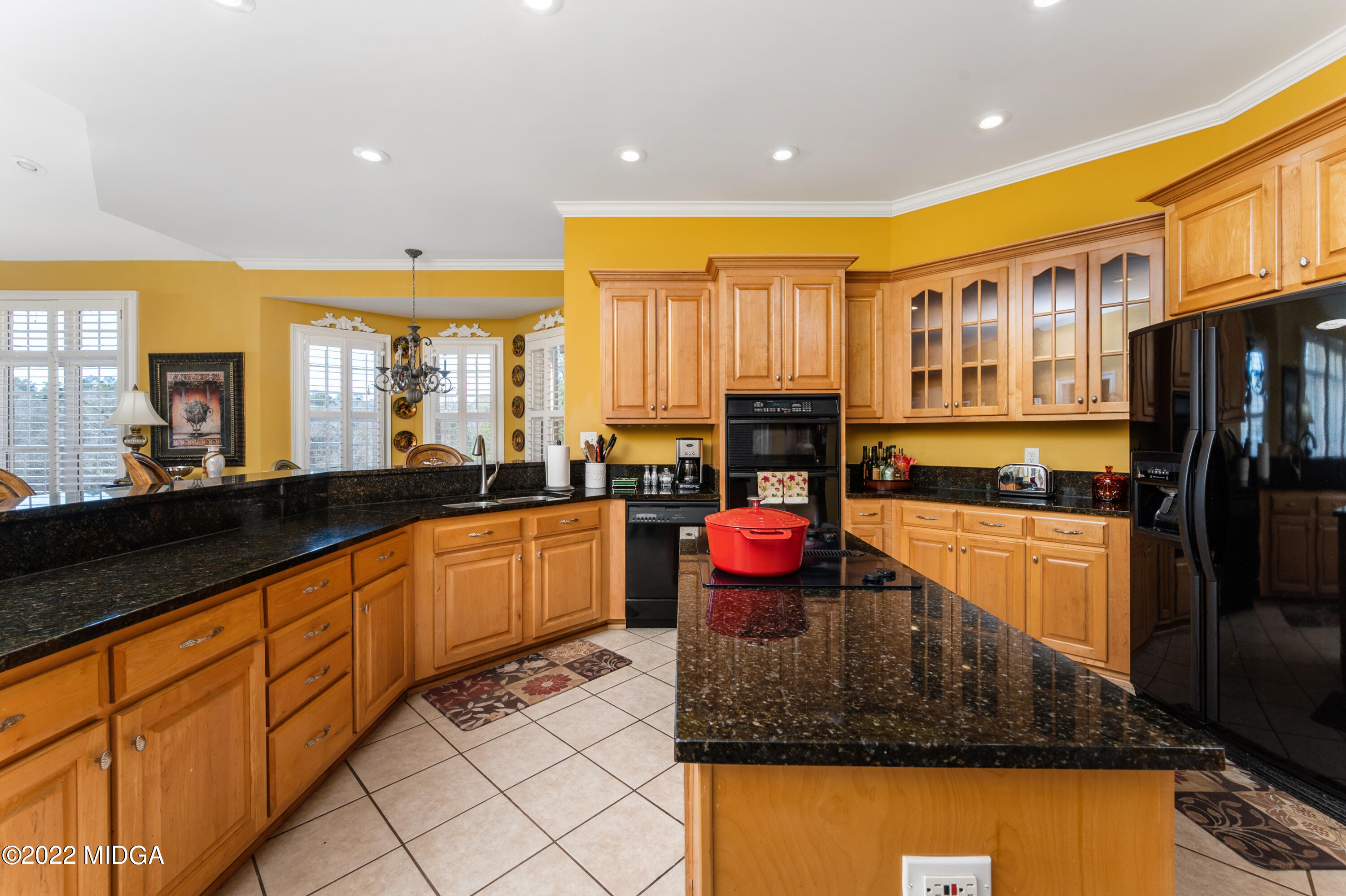 176 Tumbling Shoals Drive Gray, GA 31032 - Photo 30 of 51 a kitchen with stainless steel appliances granite countertop a refrigerator a stove top oven and a sink with wooden floor