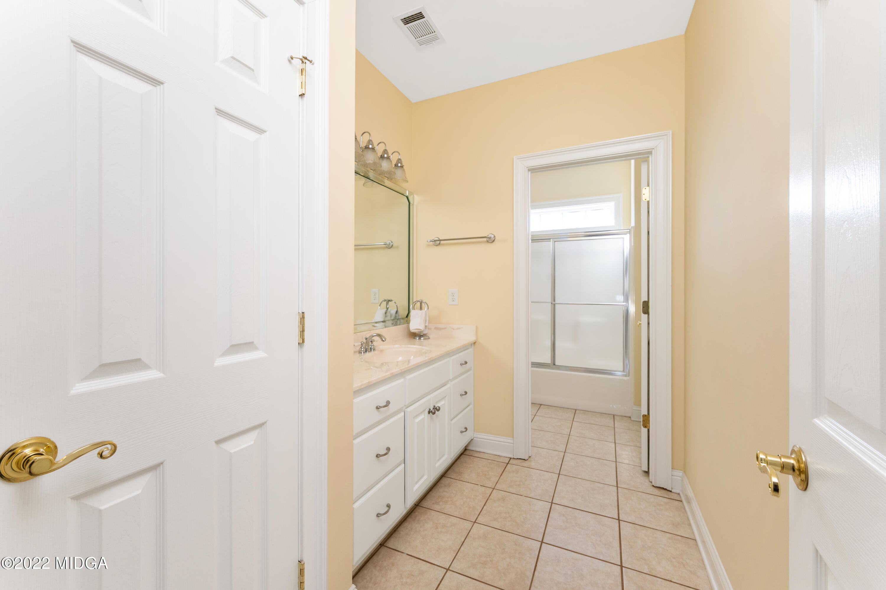 176 Tumbling Shoals Drive Gray, GA 31032 - Photo 37 of 51 a bathroom with a double vanity sink a toilet and a mirror