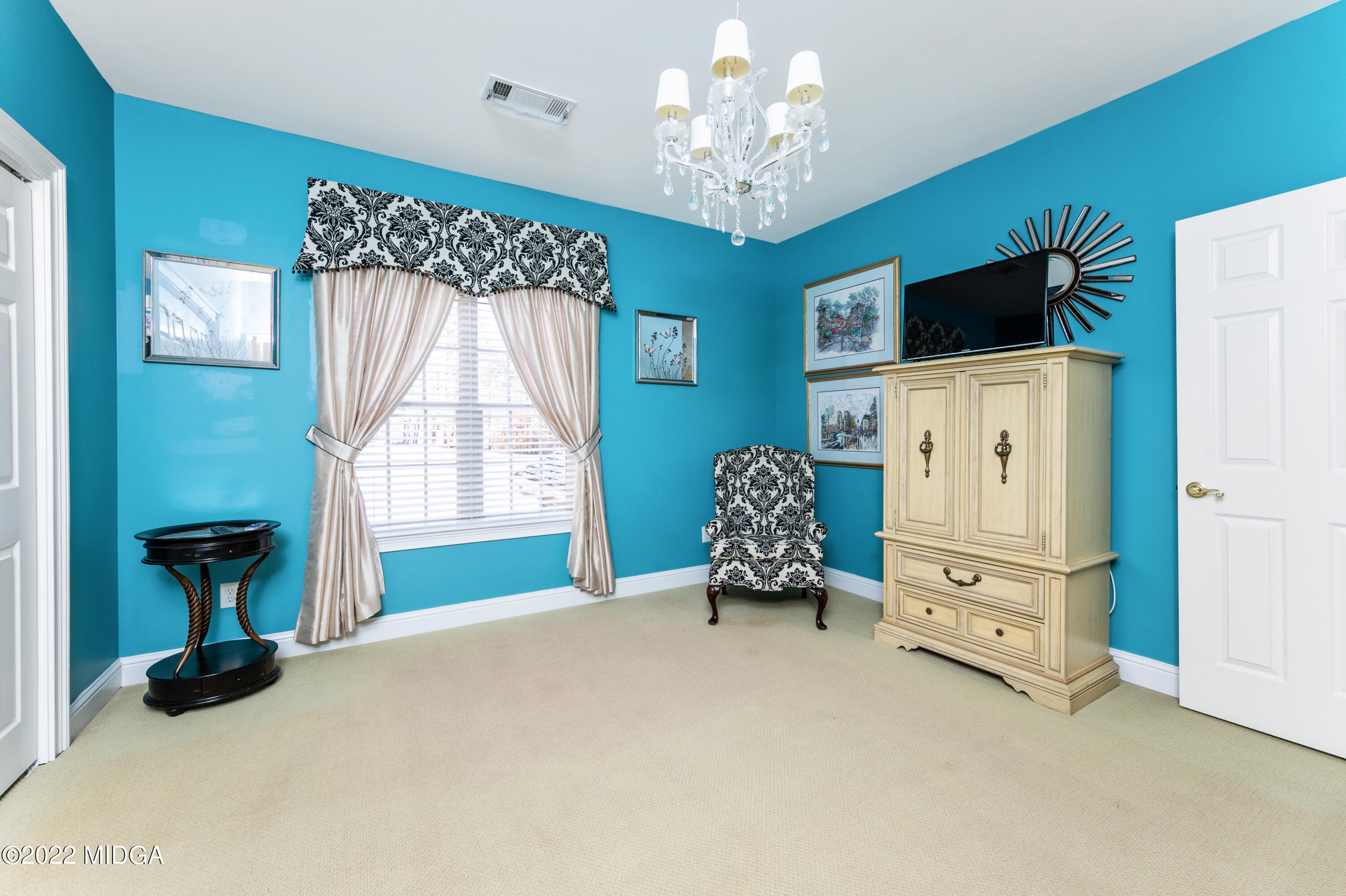 176 Tumbling Shoals Drive Gray, GA 31032 - Photo 41 of 51 a living room with furniture and a chandelier
