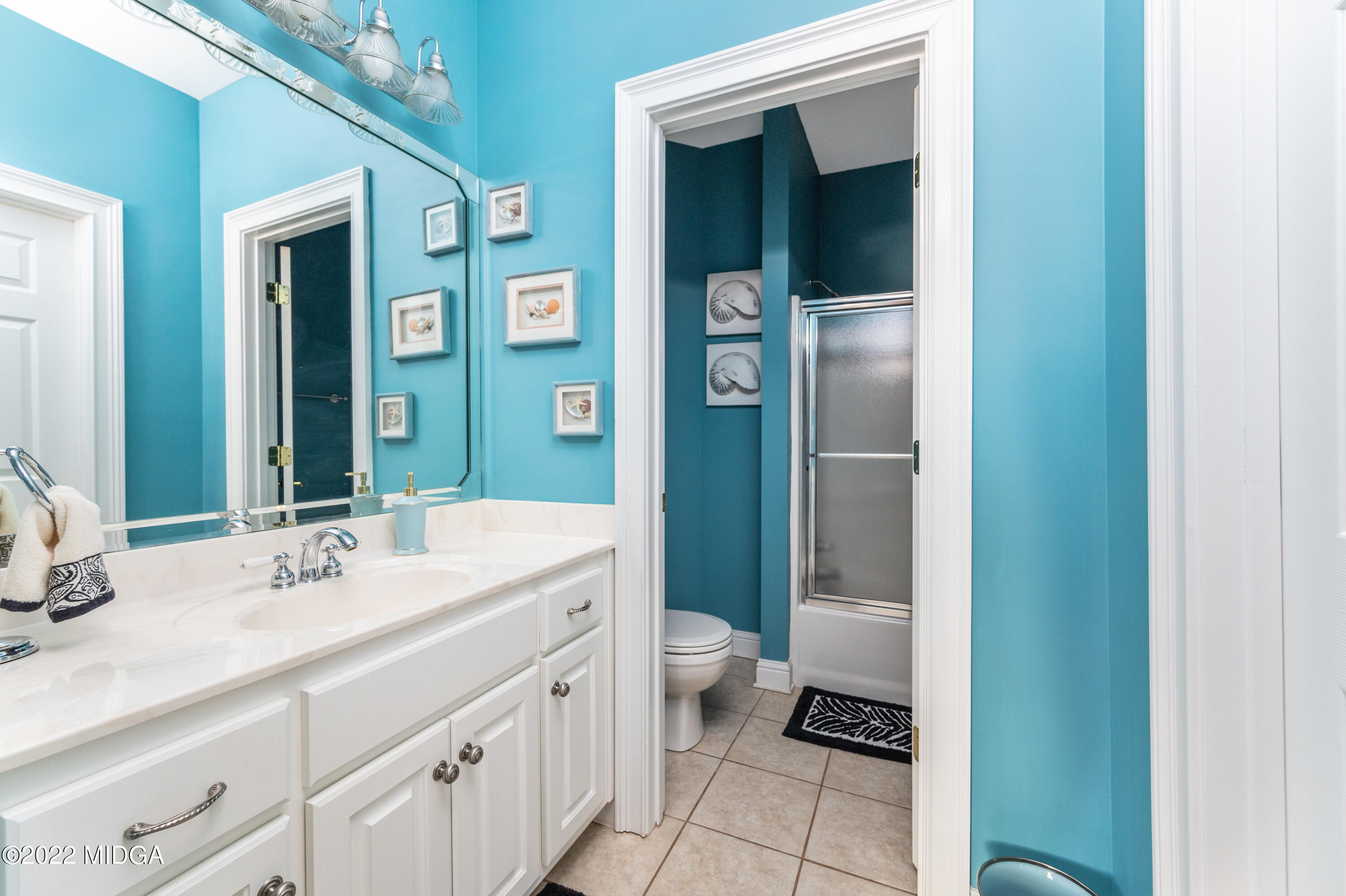 176 Tumbling Shoals Drive Gray, GA 31032 - Photo 43 of 51 a bathroom with a double vanity sink and a mirror