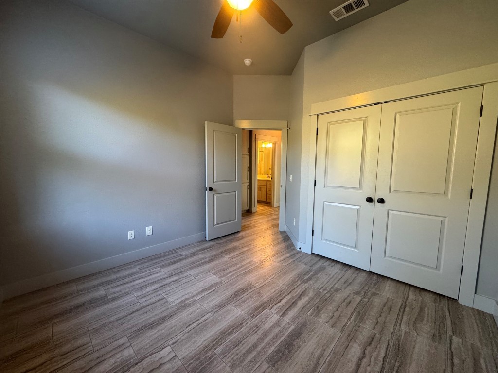 290 Hugo Road, Unit A San Marcos, TX 78666 - Photo 15 of 25 an empty room with wooden floor and shower