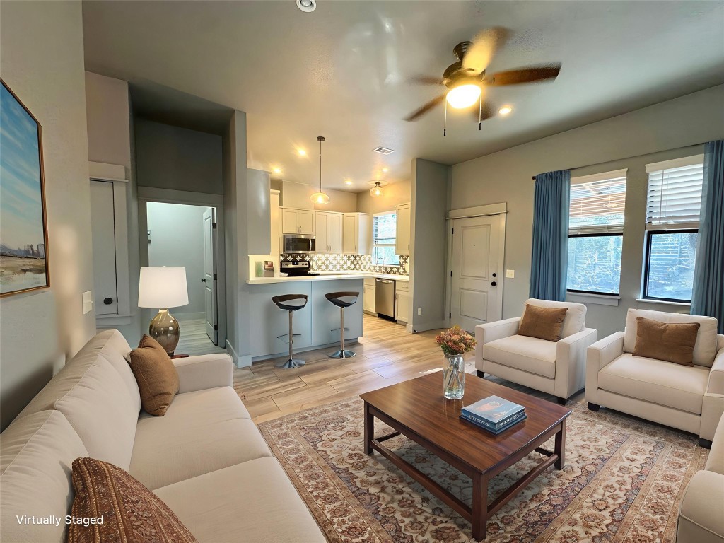290 Hugo Road, Unit A San Marcos, TX 78666 - Photo 4 of 25 a living room with furniture a rug and a chandelier