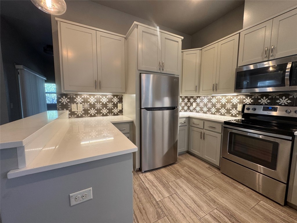 290 Hugo Road, Unit A San Marcos, TX 78666 - Photo 10 of 25 a kitchen with a sink a stove and refrigerator