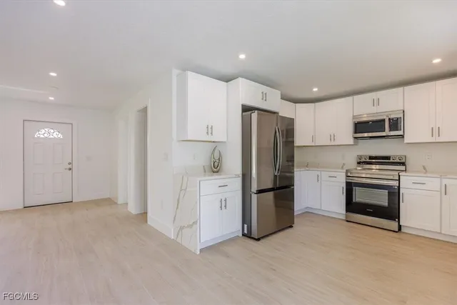 a kitchen with stainless steel appliances a refrigerator and a stove top oven