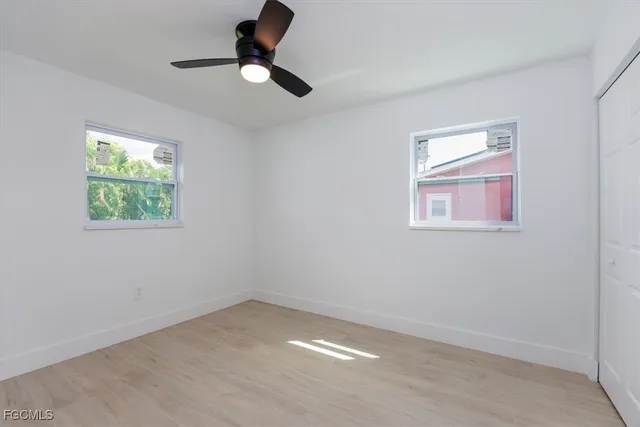 wooden floor in an empty room with a window