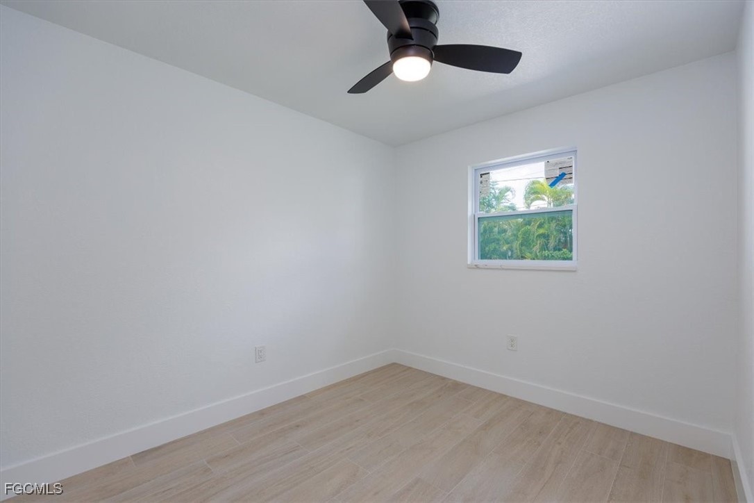 2209 Delta Street Fort Myers, FL 33907 - Photo 18 of 32 an empty room with wooden floor and windows