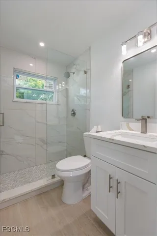 a bathroom with a sink toilet and shower