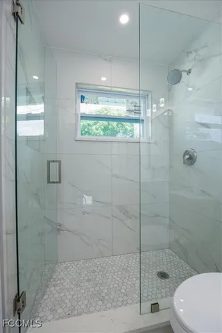 a bathroom with a shower and toilet