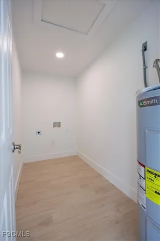 a view of a room with wooden floor and a window