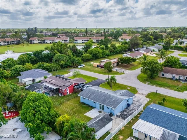 an aerial view of a house with a swimming pool outdoor seating and yard