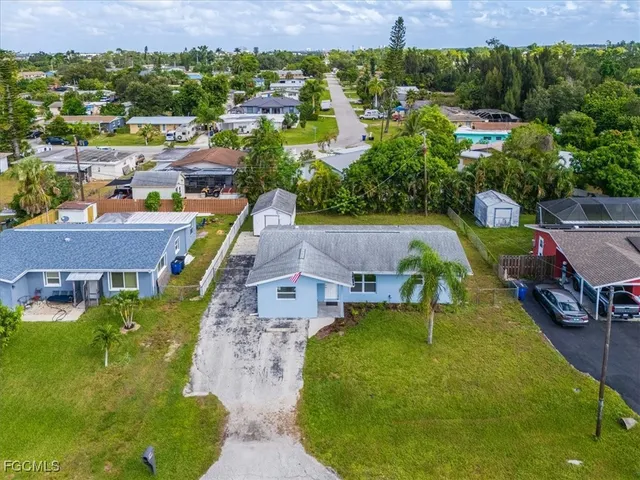 an aerial view of a house with a garden and trees