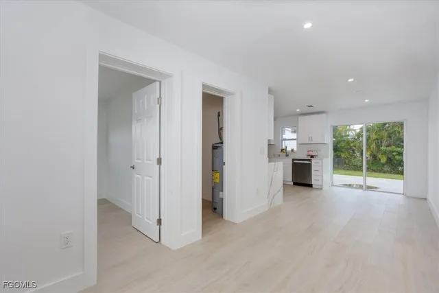 a view of a kitchen with a sink and a large window