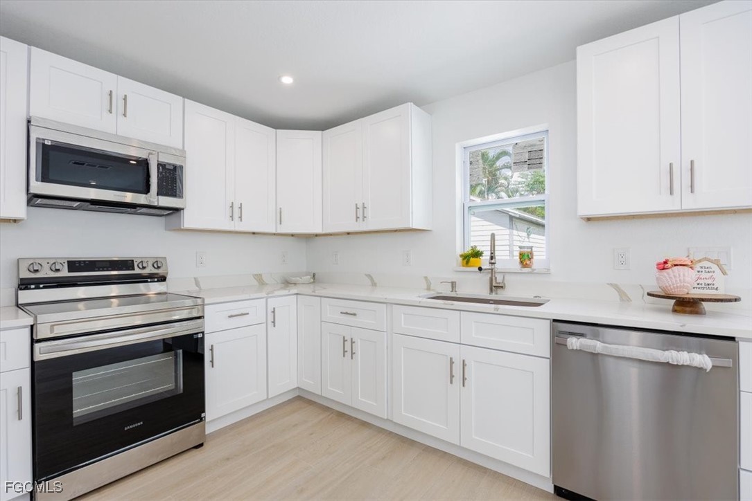 2209 Delta Street Fort Myers, FL 33907 - Photo 10 of 32 a kitchen with cabinets stainless steel appliances and sink