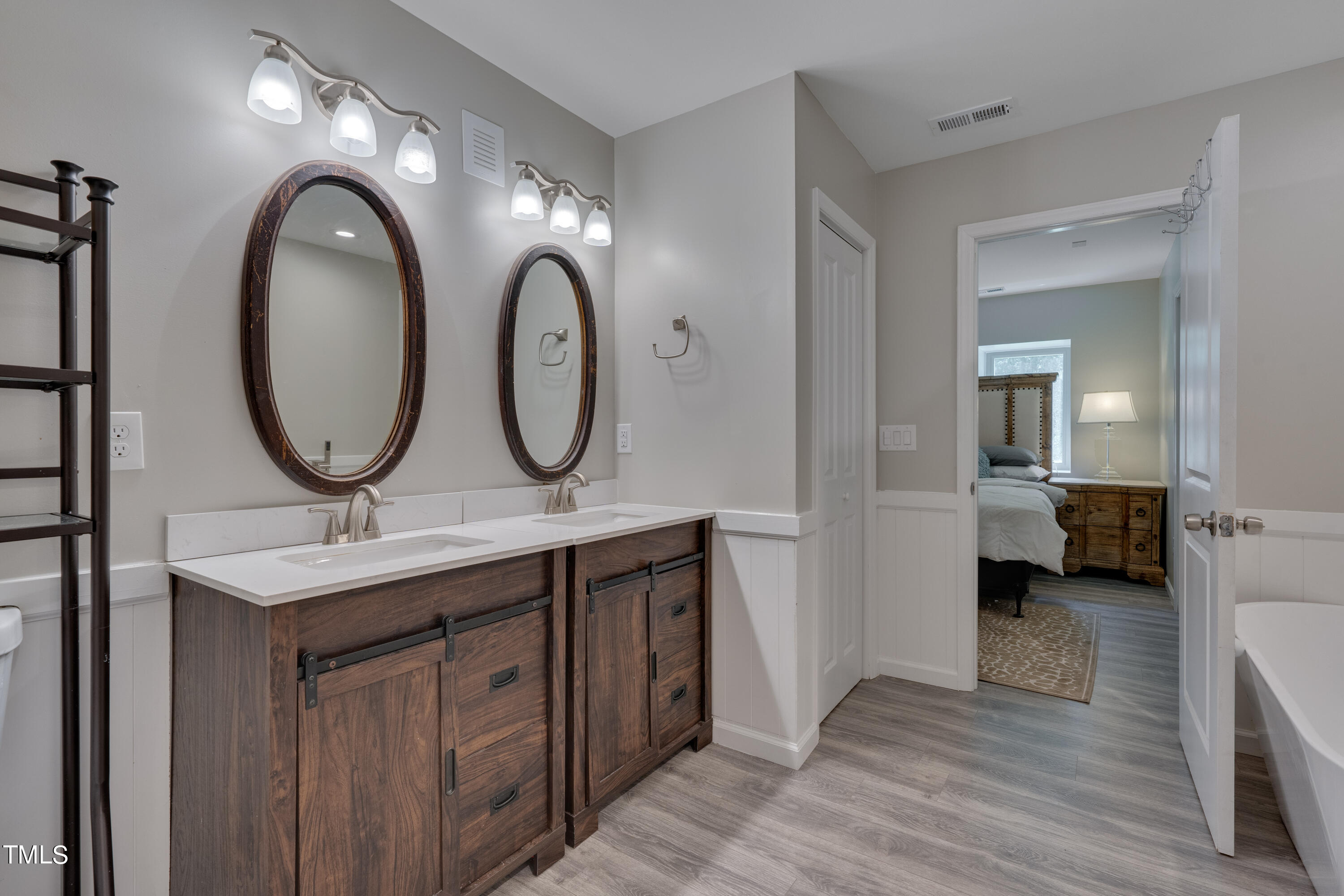 1620 Riddle Road Durham, NC 27713 - Photo 14 of 18 a bathroom with a double vanity sink and a mirror