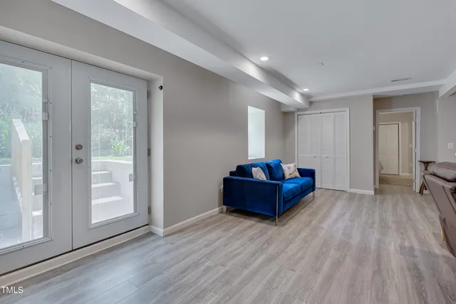 a view of a room with wooden floor and window