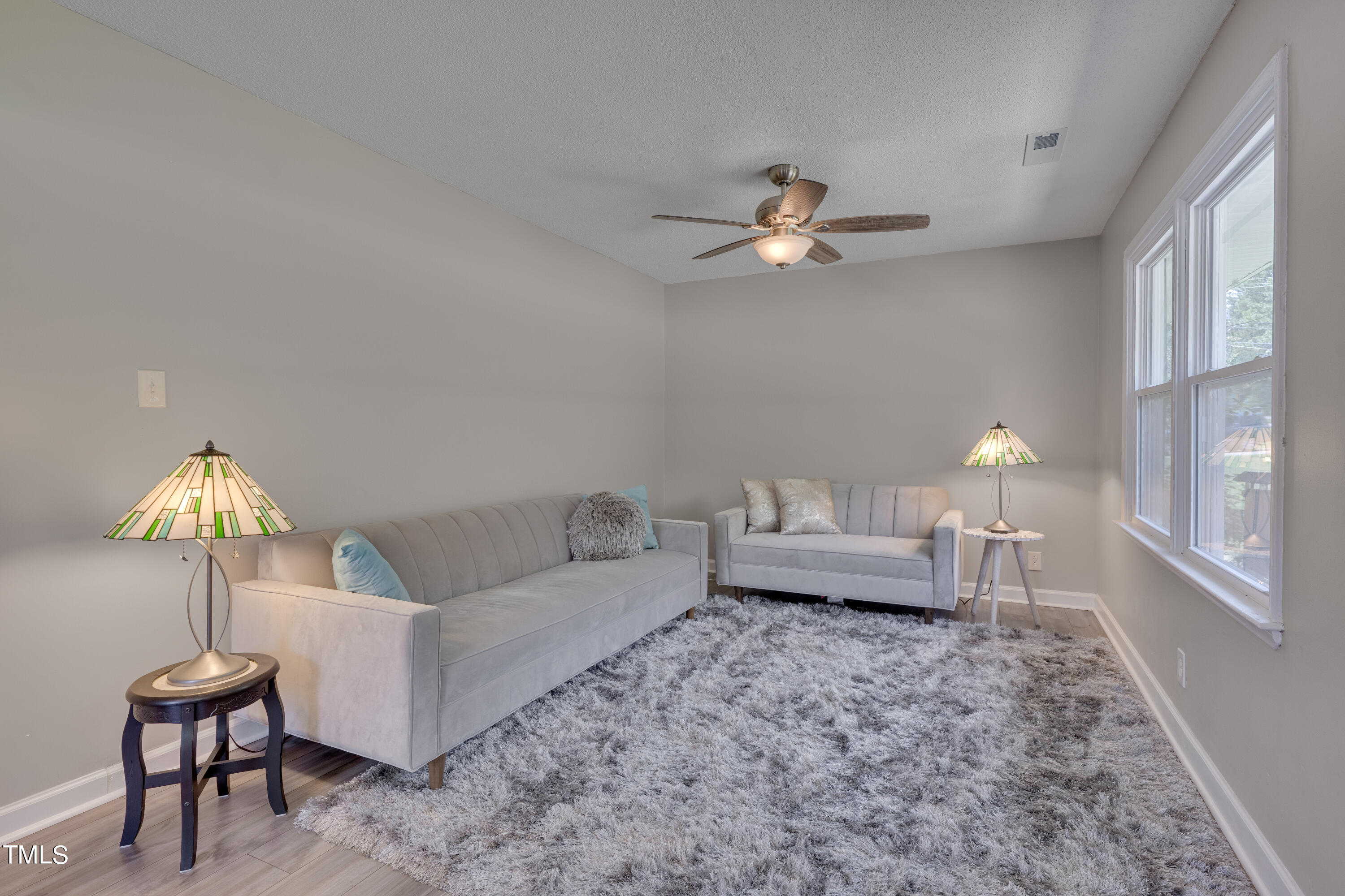 1620 Riddle Road Durham, NC 27713 - Photo 3 of 18 a living room with furniture and a lamp