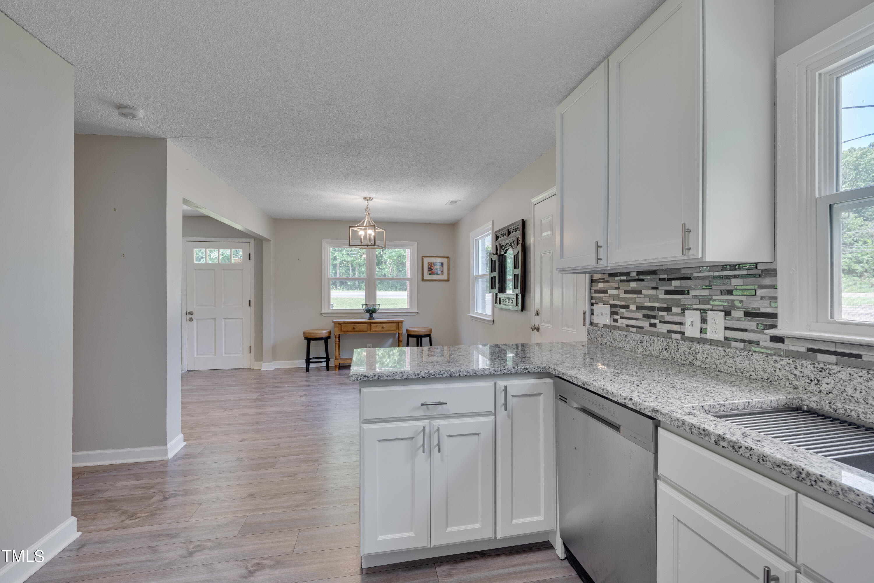 1620 Riddle Road Durham, NC 27713 - Photo 6 of 18 a kitchen with sink cabinets and window