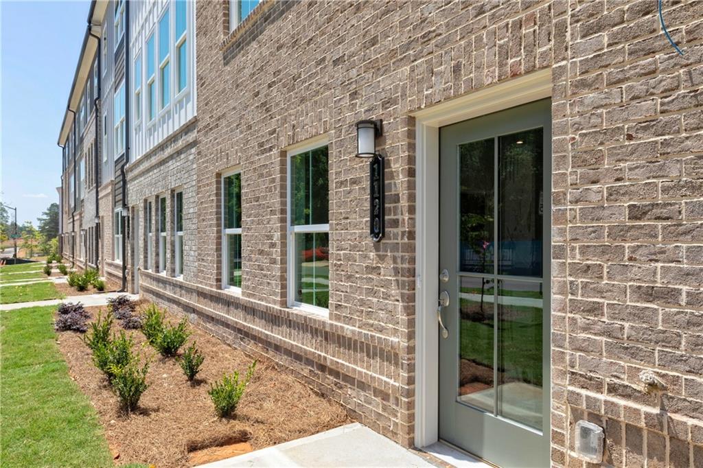 a view of a brick house with a large windows