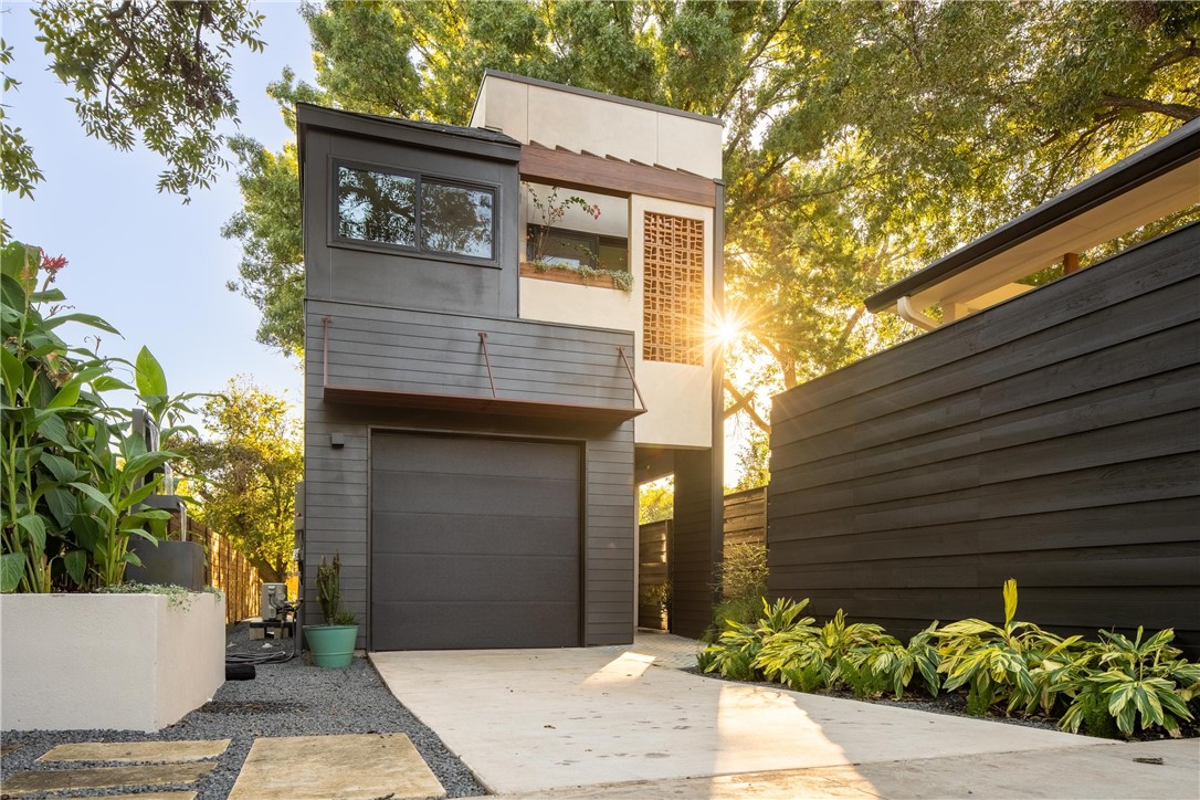 a front view of a house with plants