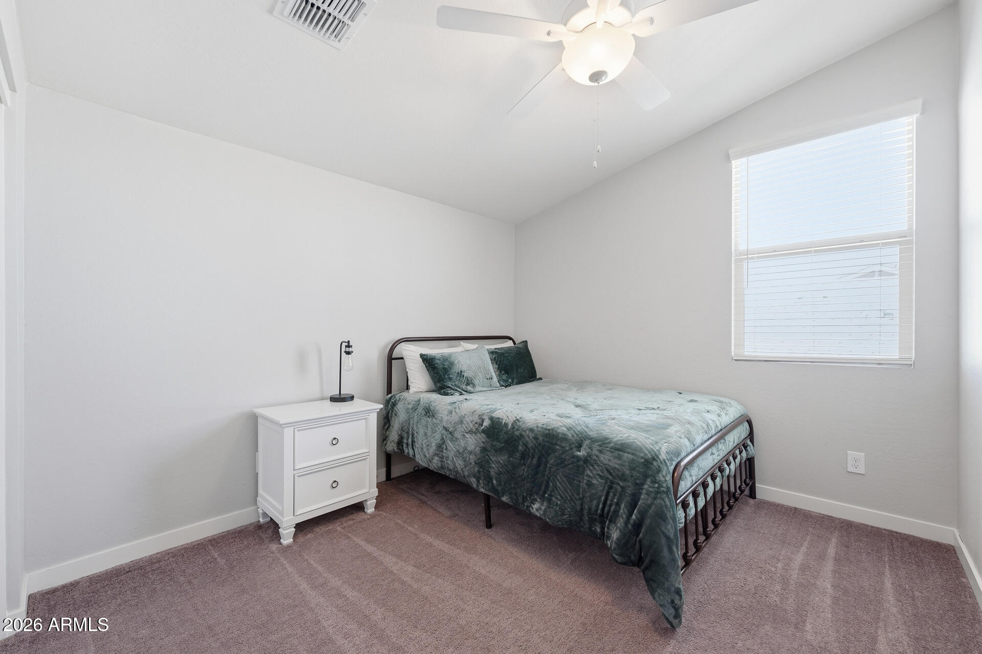 23069 East Mayberry Road Queen Creek, AZ 85142 - Photo 30 of 48 a spacious bedroom with a bed and a chandelier