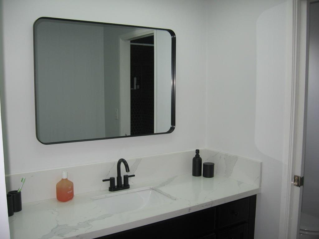 3901 Atwood Drive Modesto, CA 95355 - Photo 1 of 1 a bathroom with a sink and a mirror