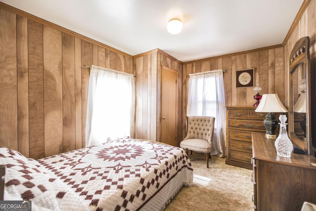 205 Georgia Avenue Fort Valley, GA 31030 - Photo 15 of 23 a bedroom with a bed and wooden floor
