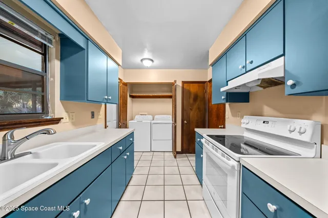 a kitchen with a sink cabinets and stainless steel appliances