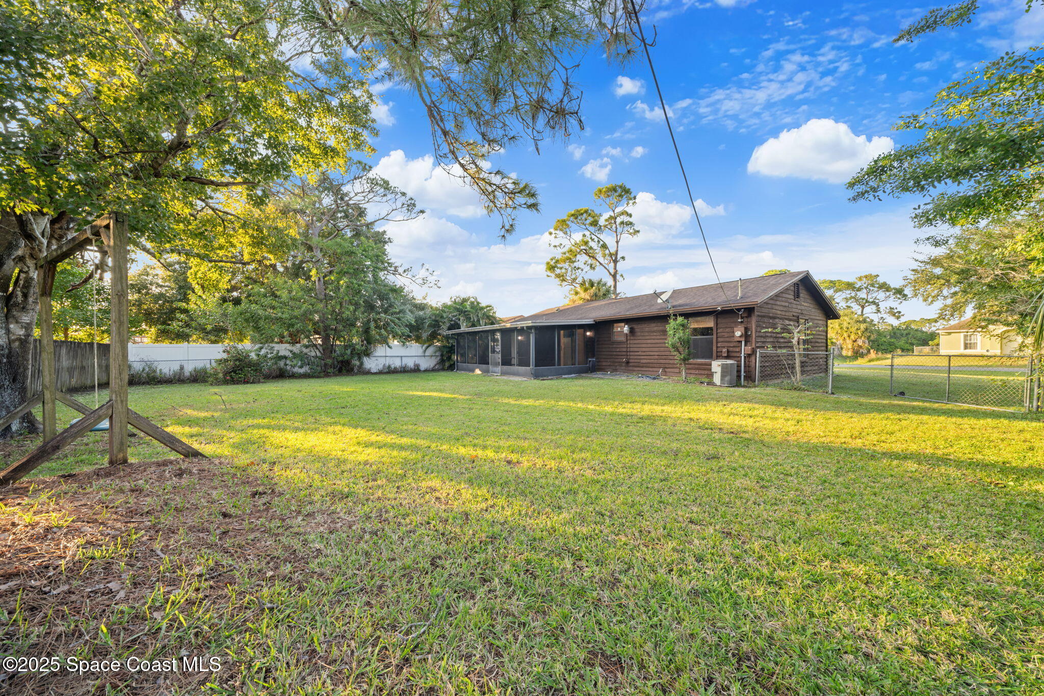 410 Albenga Road Northwest Palm Bay, FL 32907 - Photo 18 of 23 a front view of a house with a yard