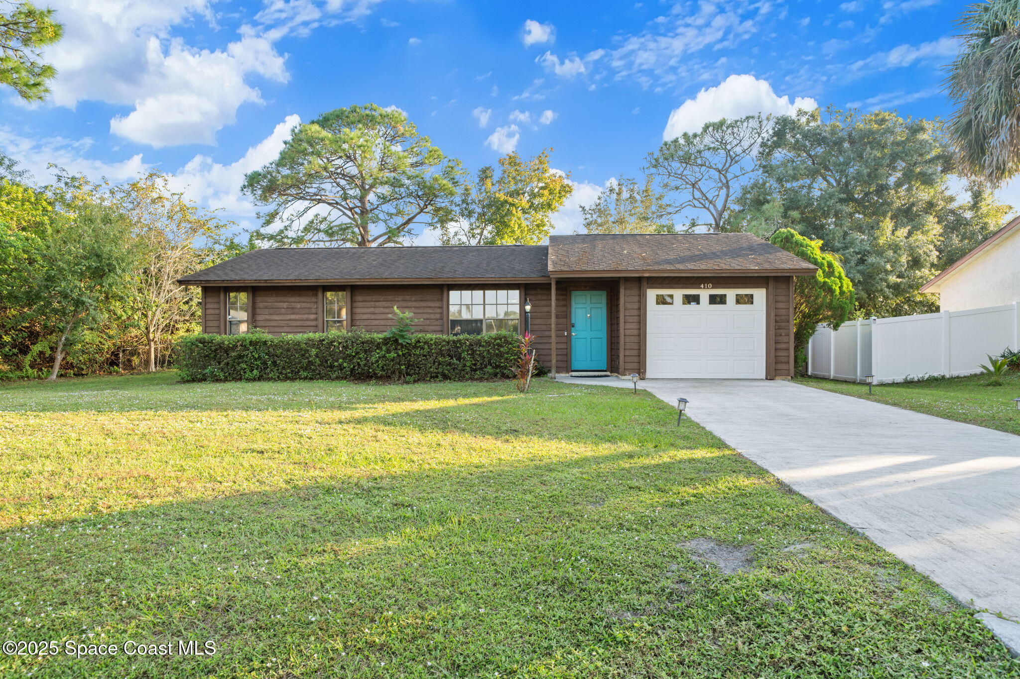 410 Albenga Road Northwest Palm Bay, FL 32907 - Photo 23 of 23 a view of a house with a yard and garage