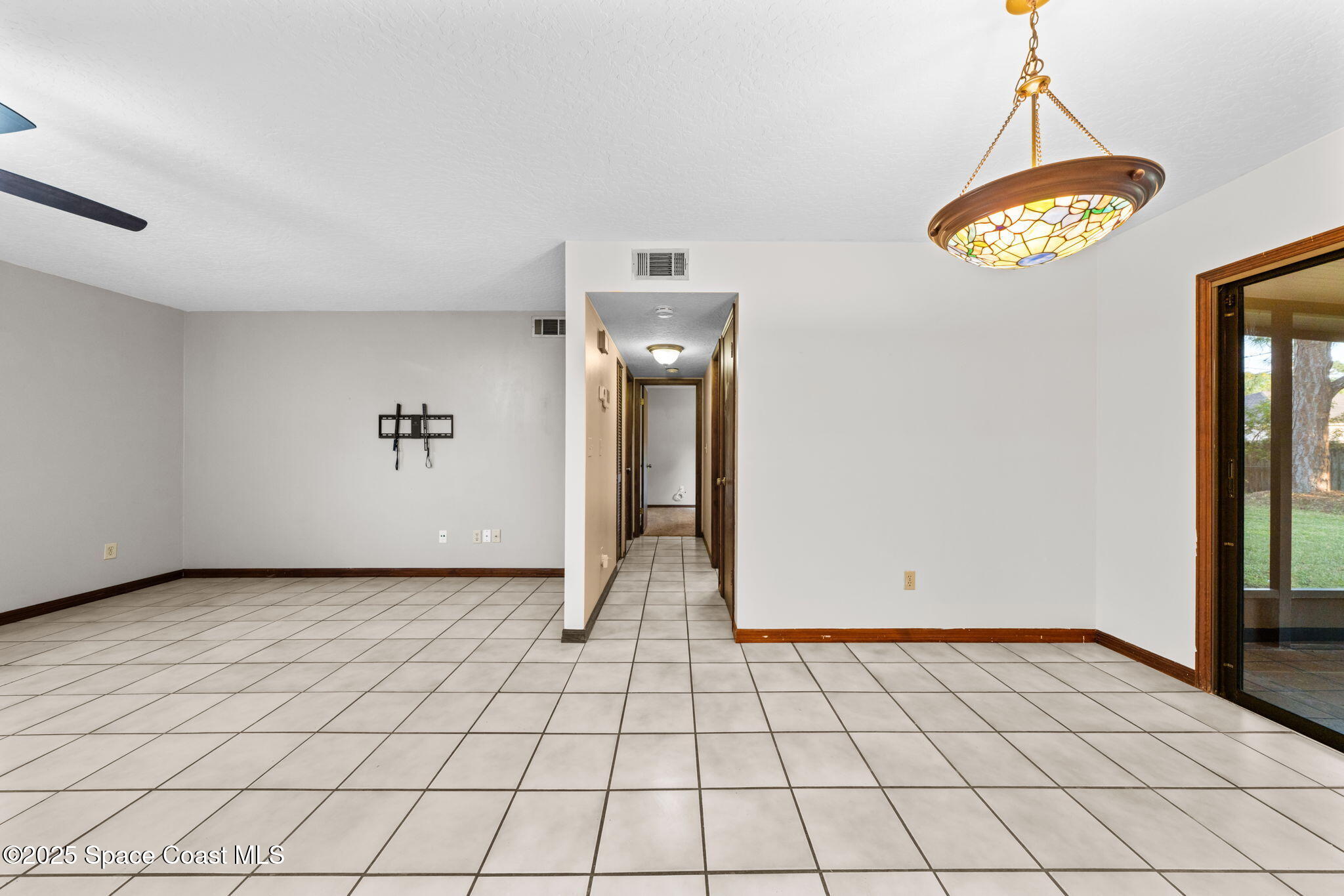 410 Albenga Road Northwest Palm Bay, FL 32907 - Photo 5 of 23 a view of an empty room and window
