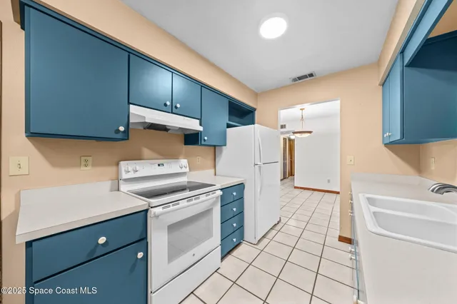 a kitchen with a stove cabinets and a refrigerator