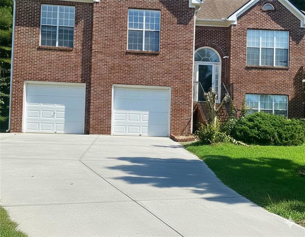 750 Legacy Place Southwest Atlanta, GA 30331 - Photo 1 of 21 a front view of a house with a yard and garage