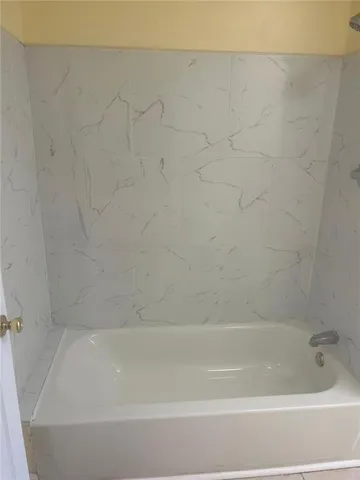 a bathroom with a granite countertop sink a toilet and a mirror