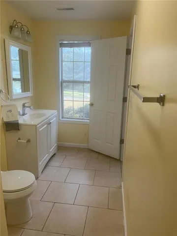 a kitchen with stainless steel appliances a white stove top oven cabinets and a wooden floor