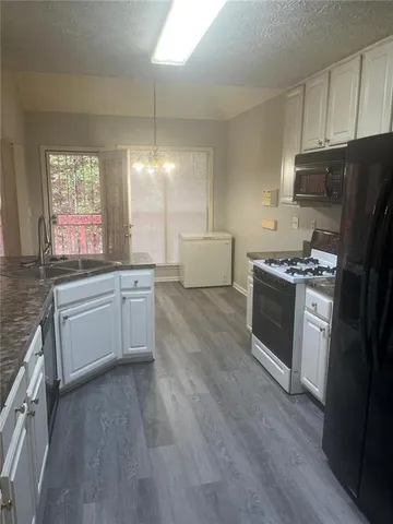 a kitchen with kitchen island granite countertop stainless steel appliances a sink stove and refrigerator