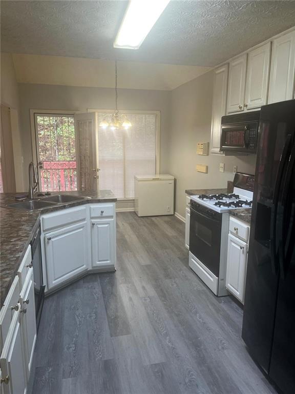 750 Legacy Place Southwest Atlanta, GA 30331 - Photo 13 of 21 a kitchen with stainless steel appliances a white stove top oven cabinets and a wooden floor
