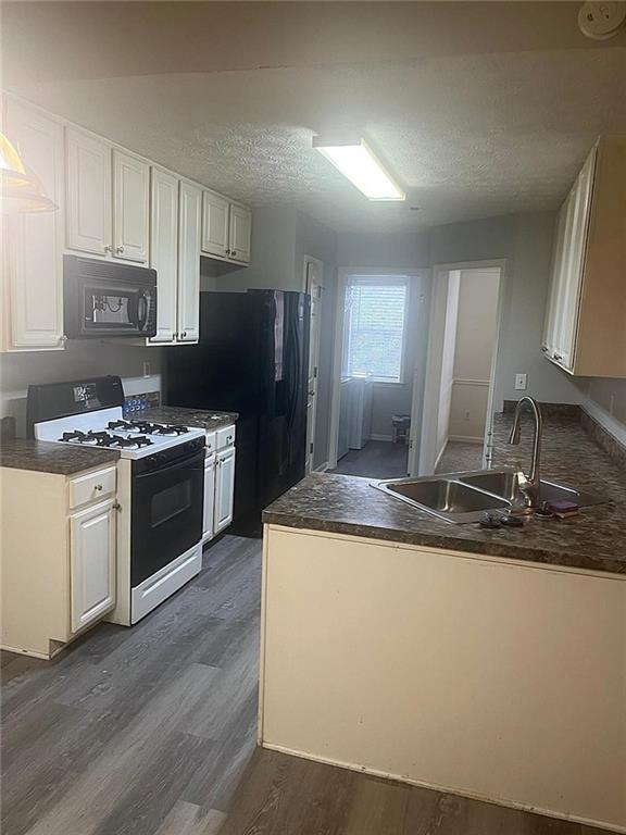750 Legacy Place Southwest Atlanta, GA 30331 - Photo 14 of 21 a kitchen with kitchen island granite countertop stainless steel appliances a sink stove and refrigerator