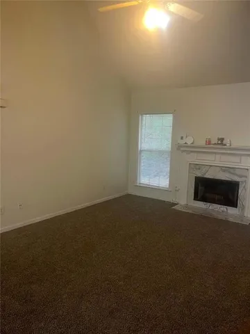 a view of empty room with a fireplace