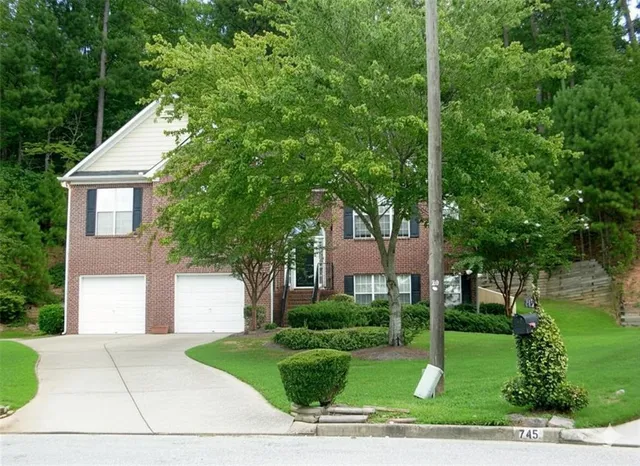 a front view of a house with a yard