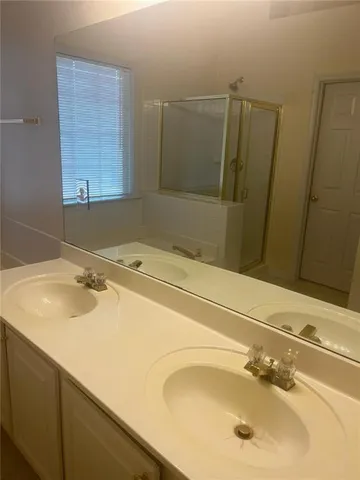 a bathroom with bathtub and shower