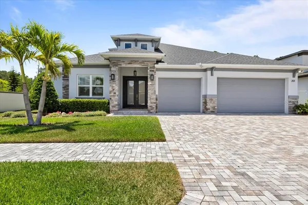 a front view of a house with a yard and garage
